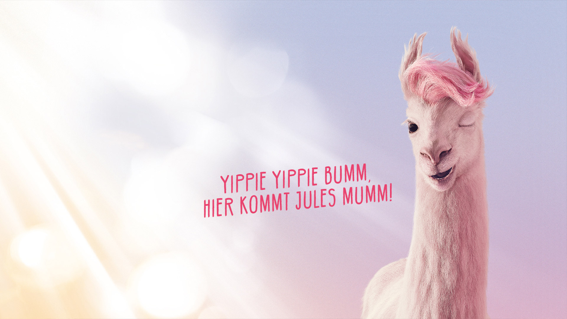 Das pinke Lama Jules zwinkert in die Kamera. Daneben steht "Yippie yippie bumm, hier kommt Jules Mumm!".